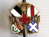 a badge with a cross and a sword on it