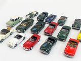 a lot of toy cars that are on a white surface