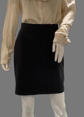 a mannequin mannequin wearing a beige shirt and black skirt