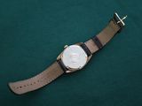 a watch that is laying on a green surface