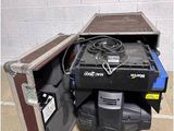 an open case with a fan inside of it on the floor