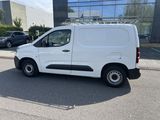 a white van that is parked in front of a building