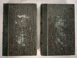 pair of antique books with green covers on a white background