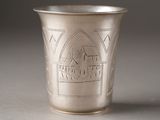 a silver cup that has a design on it