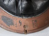 a black leather hat with writing on it on a white surface