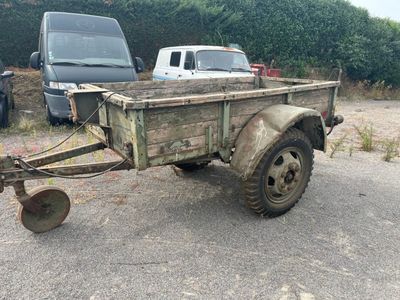 a small trailer with a plow attached to it
