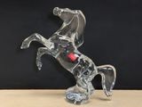 a glass sculpture of a horse that is standing on its hind legs