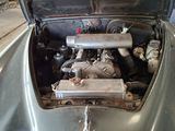 a silver car with an engine in the back of it