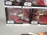 four star wars action figures on display in the box