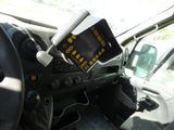a car dashboard with a monitor on it and a steering wheel
