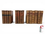 a group of books sitting on top of each other next to each other