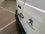 a white van parked in a parking lot next to a building
