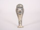 a silver vase that is sitting on a white surface