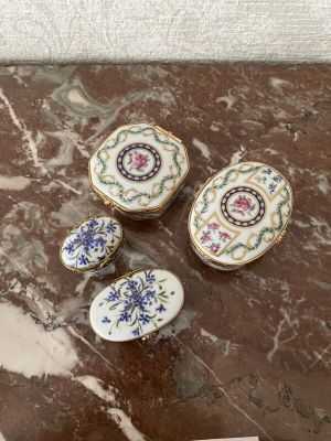 three pieces of porcelain are sitting on a marble table