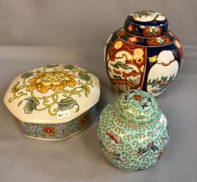 three different colored vases sitting next to each other on a table