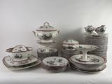 a lot of plates and cups that are sitting on a table