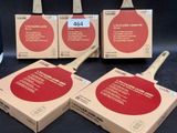 three ping pong paddles are sitting in a box on a table