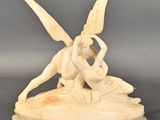 carved ivory figurine of a woman and a man on a boat