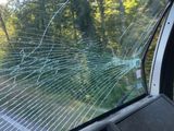 a broken windshield in the back of a car