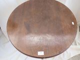 a wooden table that has a white label on it