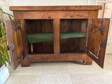 a wooden cabinet with two doors open on the floor
