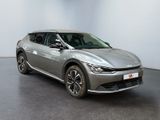 a silver car is parked in a room with a white wall