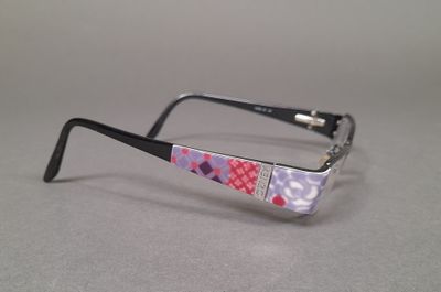 purple and white patterned glasses on a gray surface
