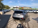 a silver car parked in a parking lot next to other cars
