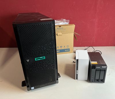 a small computer on a table next to a larger computer