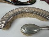 a silver spoon and a brush sitting on a table