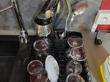 a black stove top with a bunch of cups on it