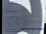 a document with a picture of a car ' s driver ' s license on it