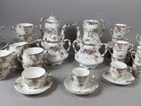 a lot of cups and saucers on the table
