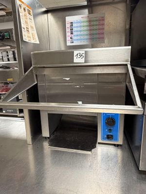 a stainless steel oven with a blue door in the middle of a kitchen