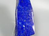 a close up of a blue stone on a white surface