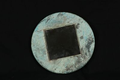 a small metal object with a black square in the middle
