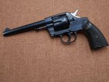 a close up of a revolver on a brown surface