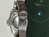 a watch that is sitting on a green case