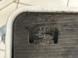 an old frying pan sitting on top of a tiled floor