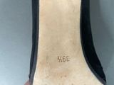 a close up of a pair of black shoes on a table