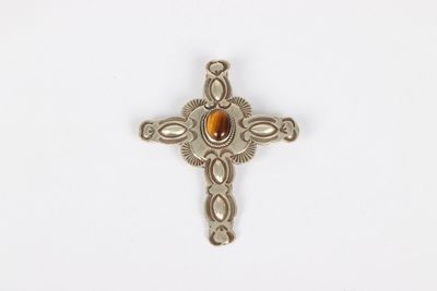 a close up of a cross with a stone in the center