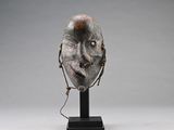 a sculpture of a face with a chain around it ' s neck