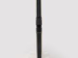a black pen sitting on top of a white stand on a white surface