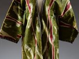 a green, red and white robe on a mannequin mannequin