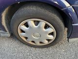 a blue car that has a flat tire on it