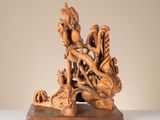 a wooden sculpture of a dragon on a table