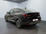 the rear end of a black car parked in a garage