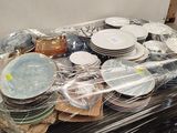a lot of plates and bowls sitting on a table