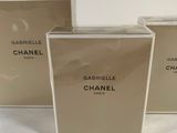 three boxes of perfume on a white surface with a white background