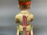 pair of ceramic figurines of a man with a hat on his head